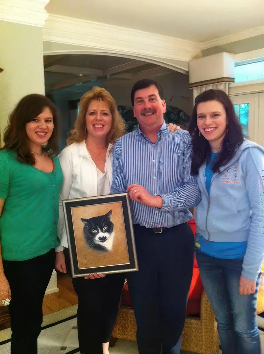 Family gathered around a memorial oil portrait of their black and white cat, Groucho