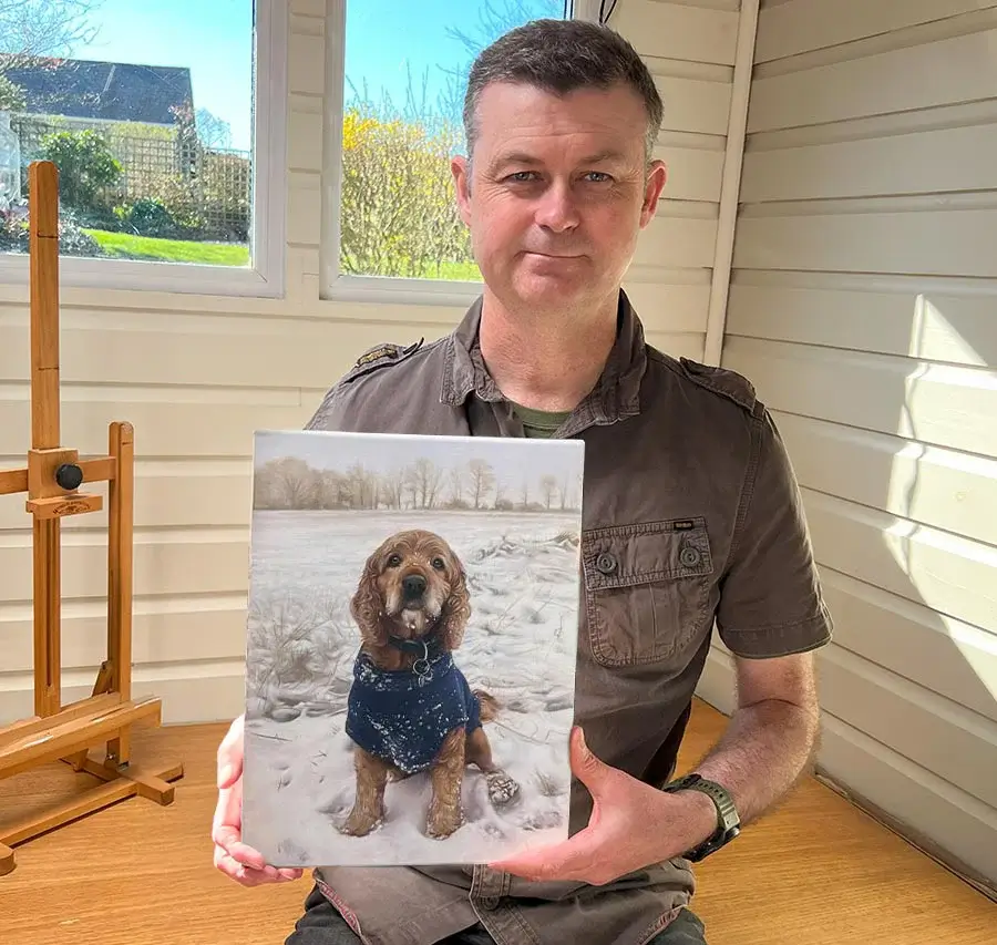 Nicholas Beall presenting a framed pet portrait to actor John Nettles