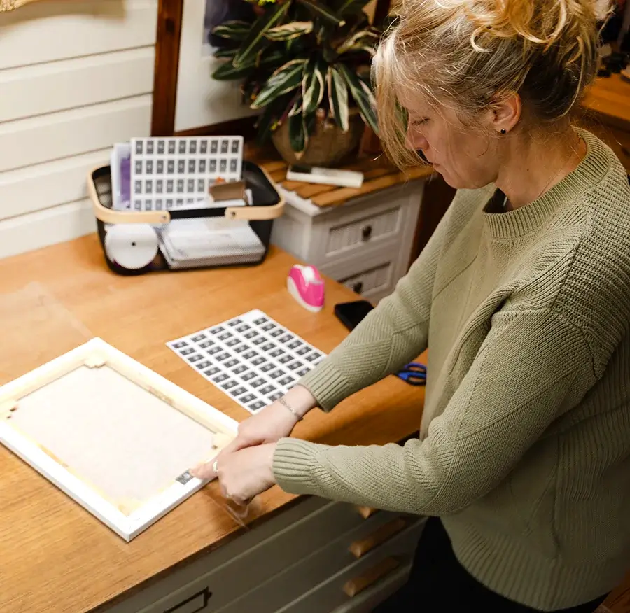 Pet portrait being carefully inspected before packaging