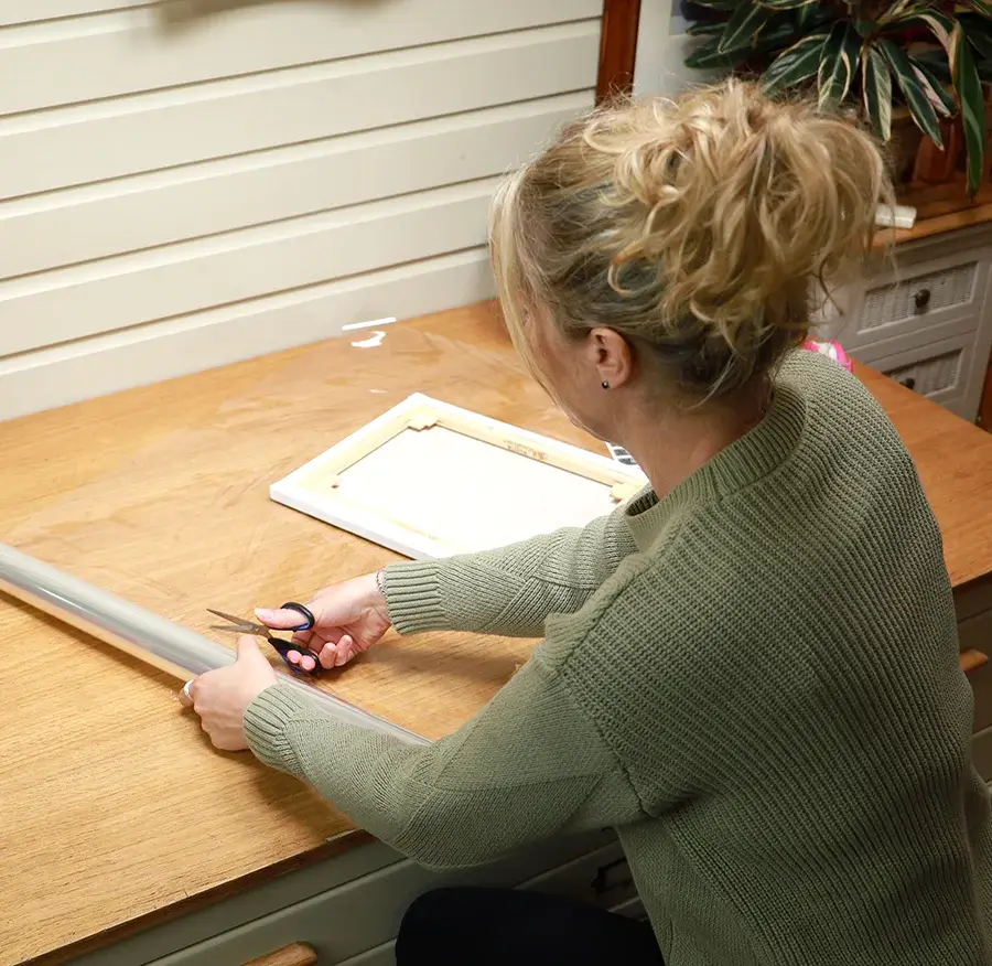 Corner protectors being applied to portrait frame