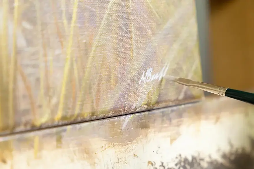 Nicholas signing finished painting