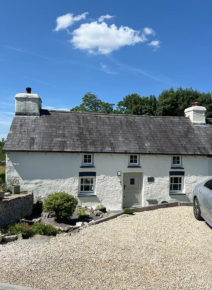 Melanie and Nicholas's traditional Welsh stone cottage with blooming flowers in mid Summer.