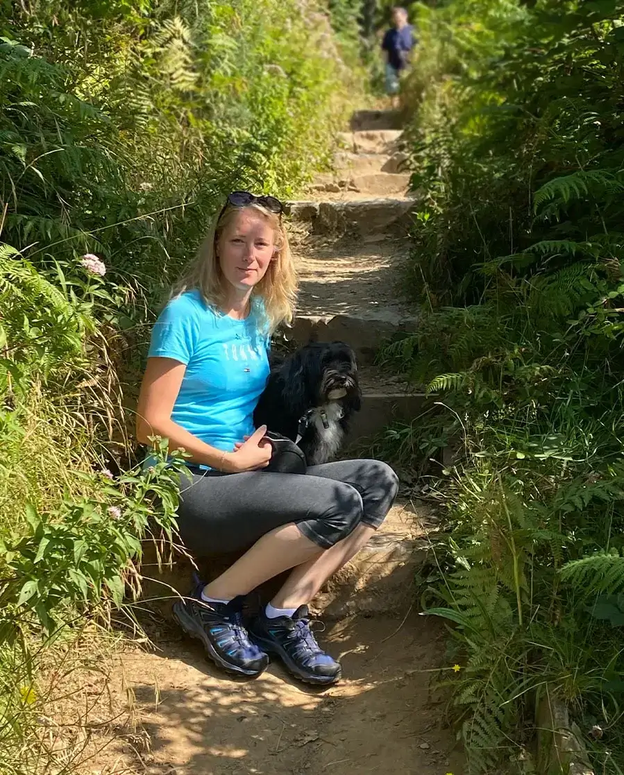 Melanie Phillips and Lily the Tibetan Terrier walking along a footpath near Bosherston Lakes in Pembrokeshire.