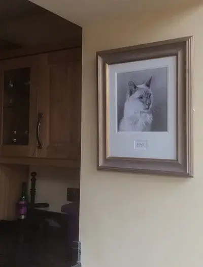 A lifelike cat portrait proudly displayed in Rebecca's home, making the pet feel present in the living space.