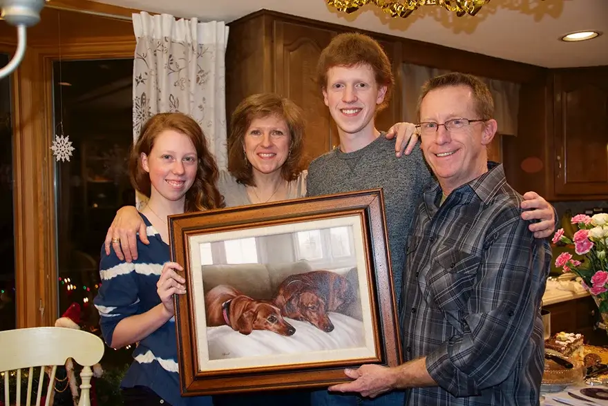 Kris Fitzpatrick and her family on Christmas Eve, celebrating her 50th birthday with the unveiling of a magnificent oil painting featuring her beloved dachshunds and their home.