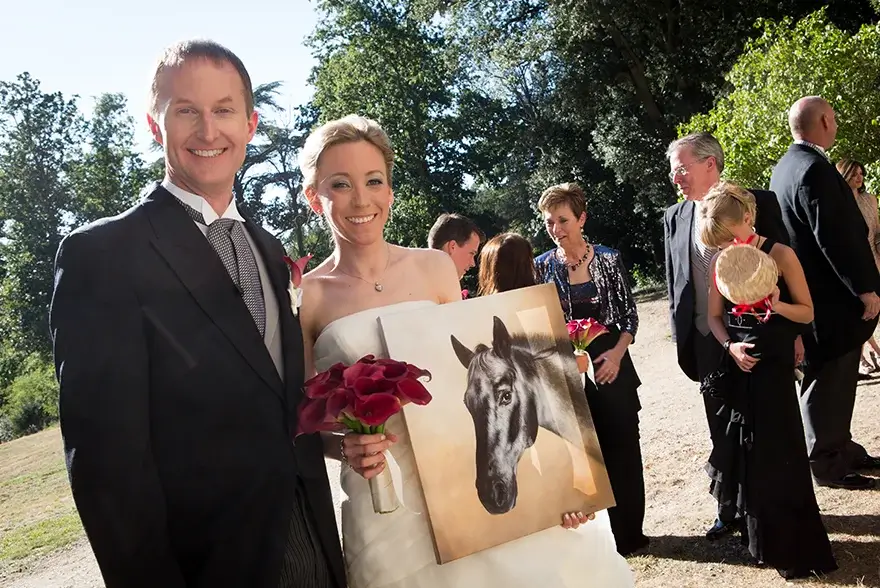 Client Kim joyfully holding her newly arrived and framed oil portrait of Jake, praising the amazing artwork and packaging.