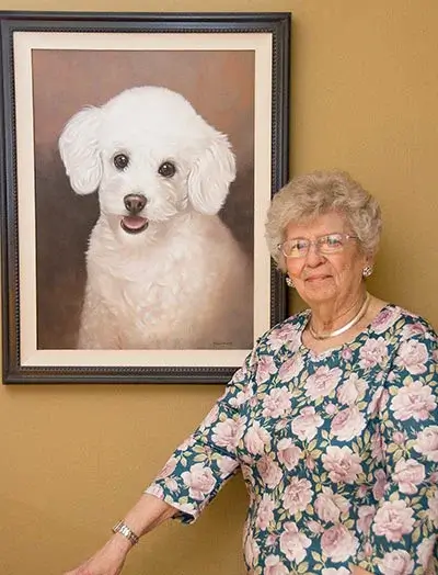A framed portrait of Samantha the dog, proudly displayed in a mother's apartment, offering comfort and admiration.