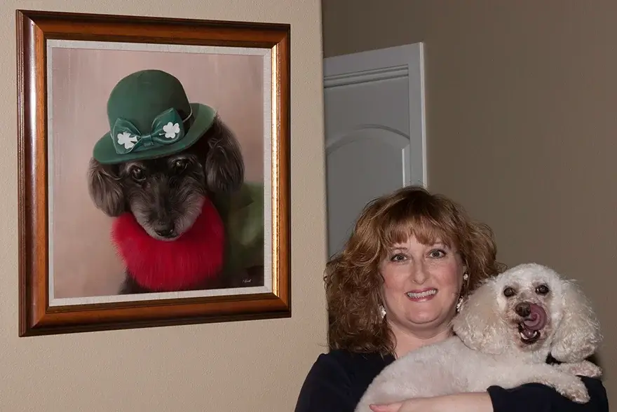 Client Tracy Maguire's dog Sarah posing somewhat reluctantly next to a framed portrait of Curly, displayed in their home.
