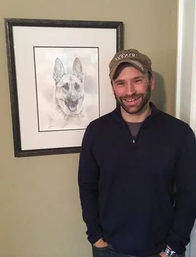 Client Caroline with her newly arrived portrait of Romy, expressing how it looks even better in person.